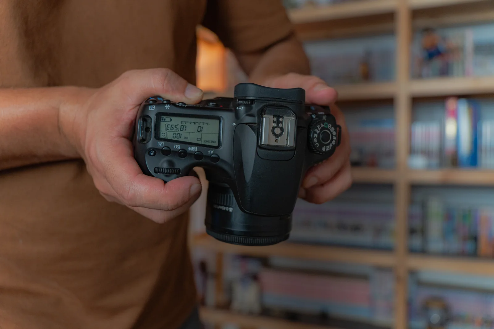 Holding the Canon 60D showing its grip, top LCD and physical controls